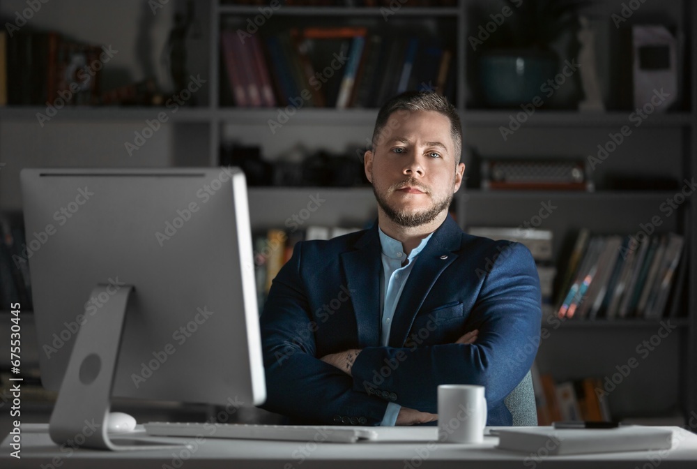 Man in dark office working on pc Man in dark office working on pc