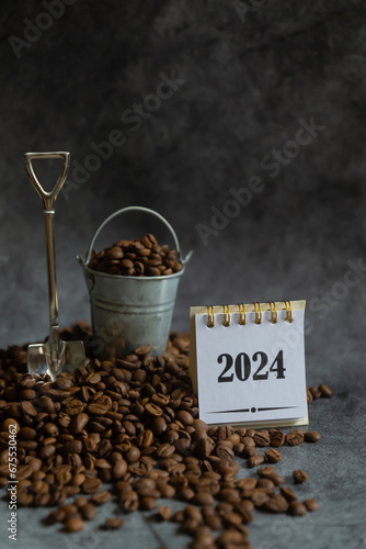 Background of freshly roasted coffee beans, 2024 calendar.