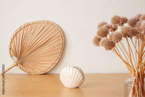Dried flowers and rattan accessories at the wooden table photo