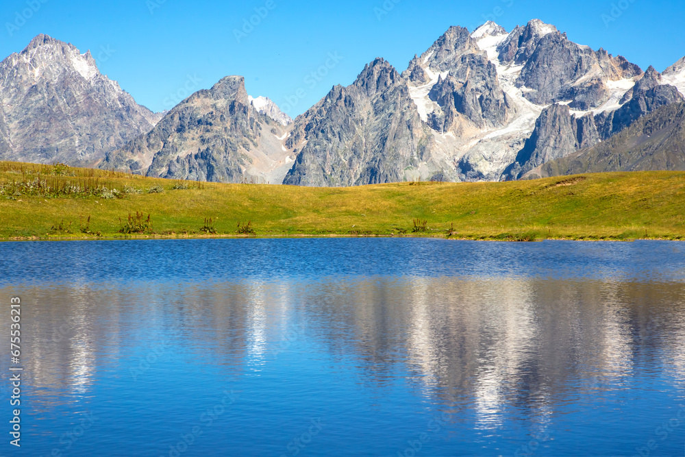 the Caucasus mountain range in the reflection of the mountain lake