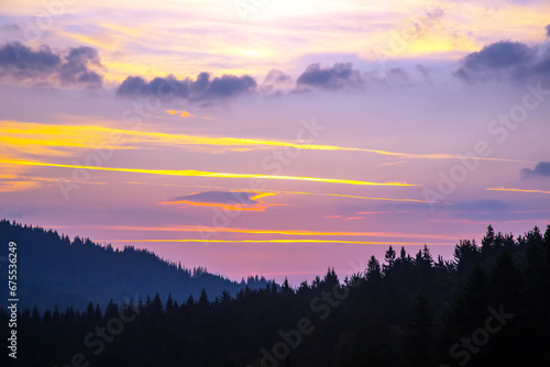brightly colorful clouds in the evening sky. Lush colored clouds in the sky before sunset © photosaint