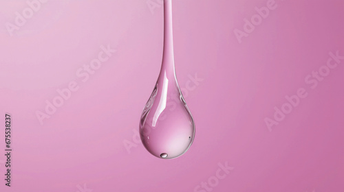 Closeup of one single floating water drop droplet isolated on pink background 