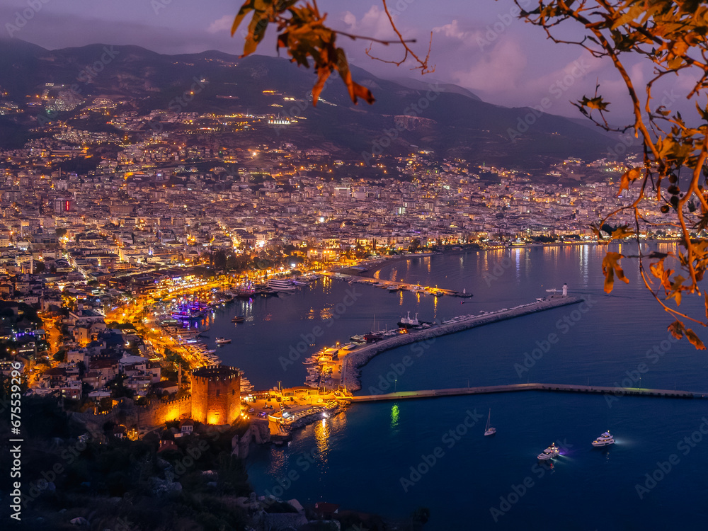 Naklejka premium View from Alanya castle to the harbor at night, city lights at evening, Night Photography.