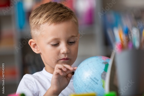 Children with globe, interesting geography learning.