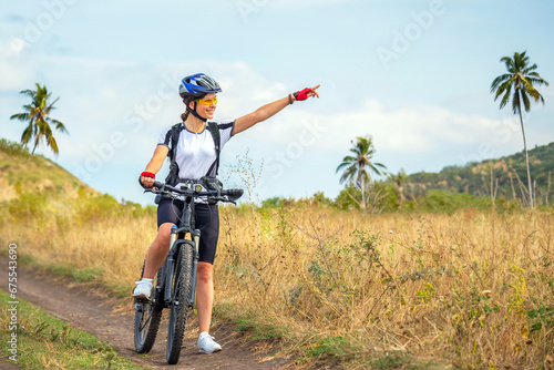 Beautiful woman cyclist on a bicycle in nature. Healthy lifestyle and sports. Leisure and hobbies