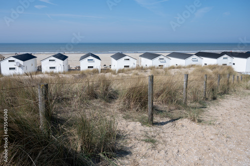 Beach holidays on sandy beach, waterfront wooden cottages in Katwijk-on-zee, North sea, Netherlands photo