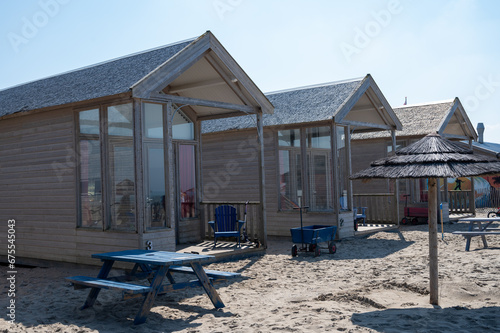 Beach holidays on sandy beach, waterfront wooden cottages in Katwijk-on-zee, North sea, Netherlands