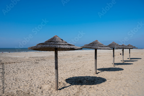 Beach holidays on sandy beach  waterfront relaxation with sun umbrella in Katwijk-on-zee  North sea  Netherlands