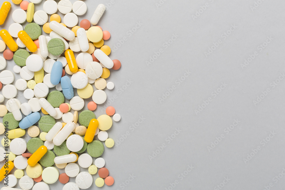 Different medical pills and capsules on color background, top view Different medical pills and capsules on color background, top view