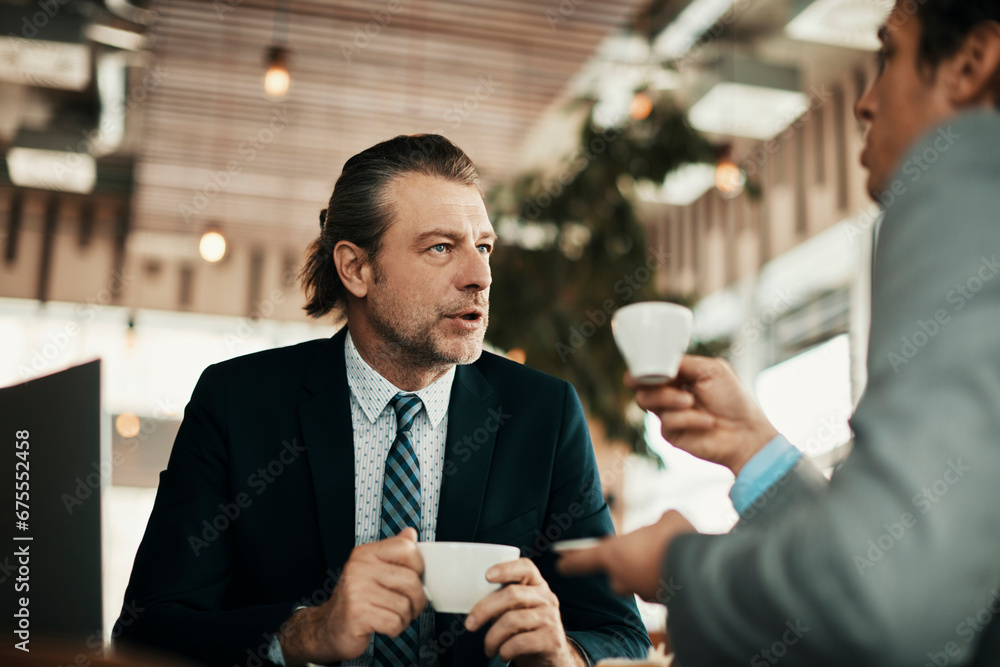 Business partners talking in a coffee shop