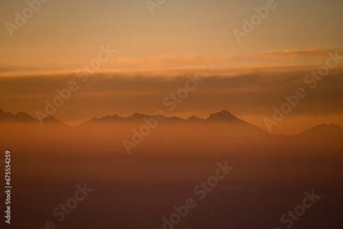 View on peaks of mountains during sunset. High mountain landscape in winter.