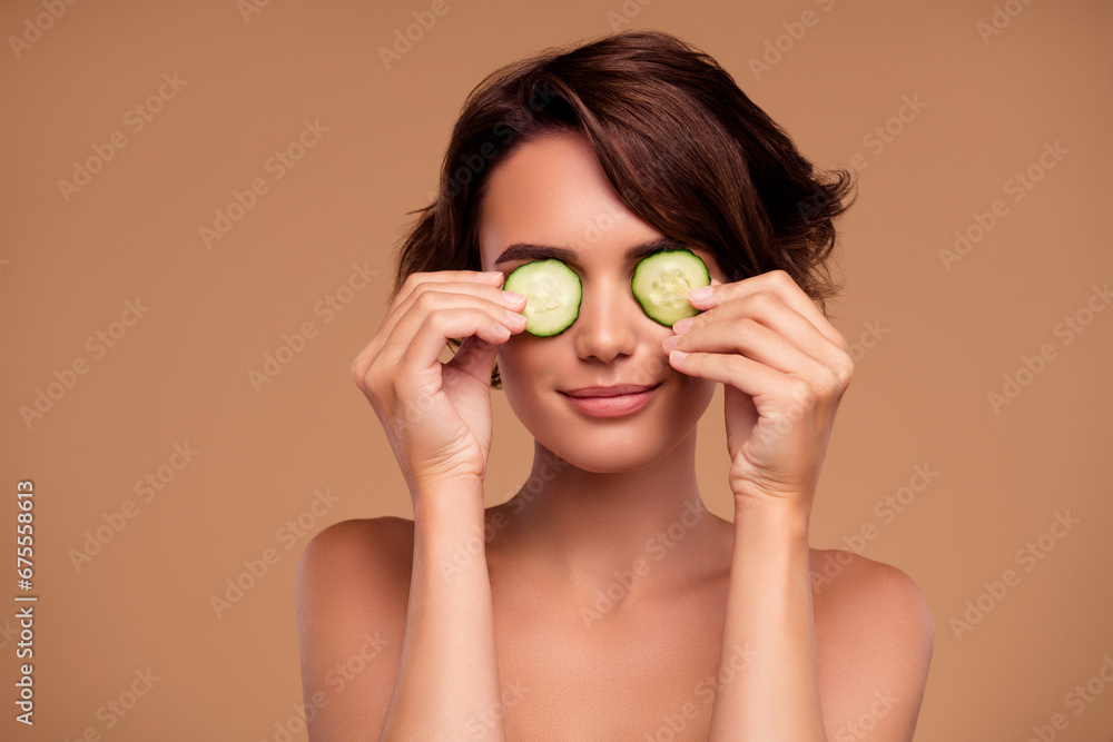 Photo of attractive lady cover eyes with cucumber apply mask scrub for flawless skin on pastel color background Photo of attractive lady cover eyes with cucumber apply mask scrub for flawless skin on pastel color background