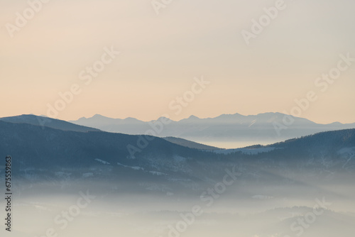 Scenery view on winter landscapes in foggy mountains covered with clouds