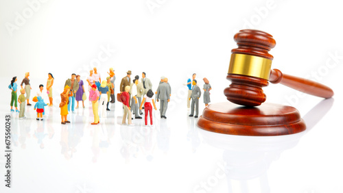 Miniature people. Many people near the gavel of law and justice. Laws to ensure the life of the society of the country