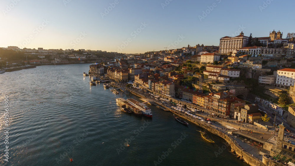 View from Bridge Dom Luis over old town at Cais da Ribeira during golden hour in the evening in Porto, Portugal