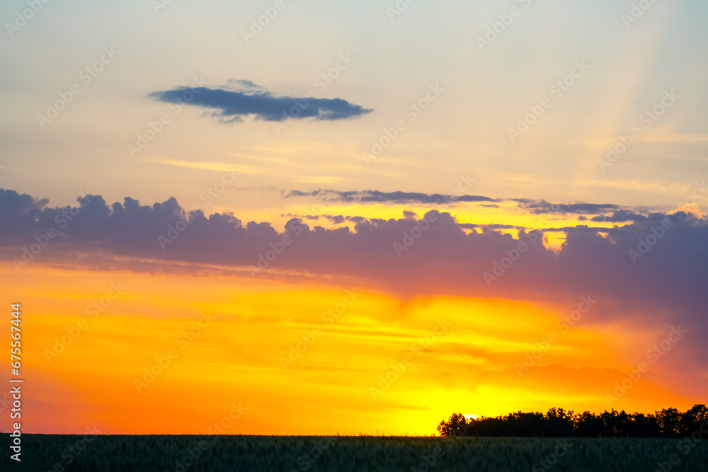 brightly colorful clouds in the evening sky. Lush colored clouds in the sky before sunset brightly colorful clouds in the evening sky. Lush colored clouds in the sky before sunset