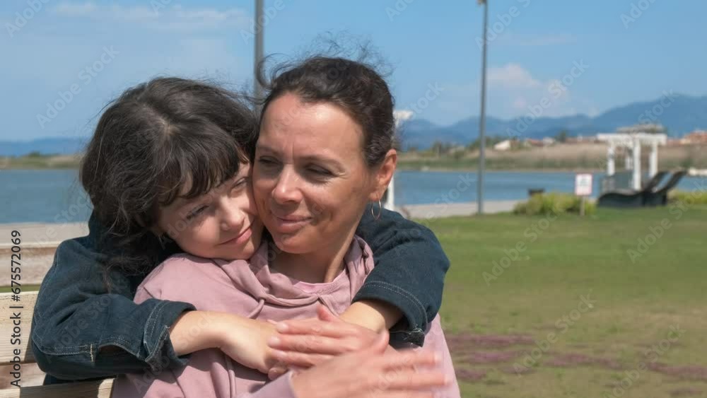 Funny hide and seek game. A smiling child play hide and seek with her mother on the bench under sun in the park. Funny hide and seek game. A smiling child play hide and seek with her mother on the bench under sun in the park.