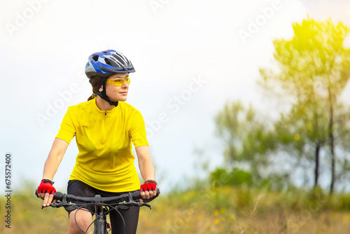 Beautiful woman cyclist on a bicycle in nature. Healthy lifestyle and sports. Leisure and hobbies