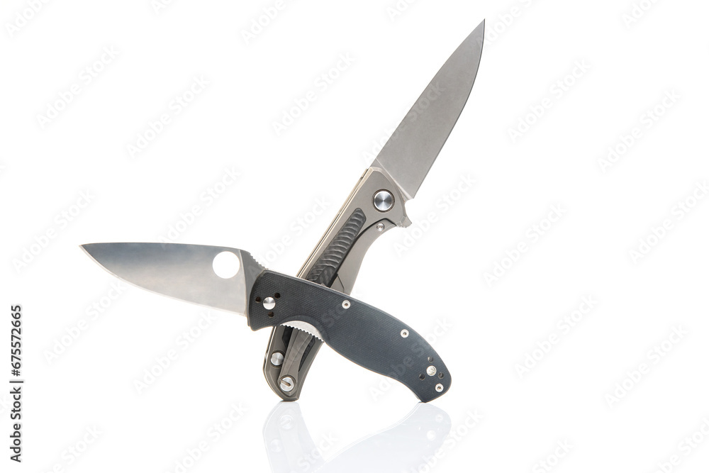 two folding knives on a white background. item for tourism and survival. two folding knives on a white background. item for tourism and survival.