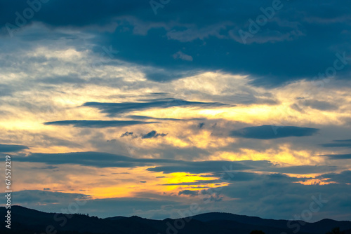 brightly colorful clouds in the evening sky. Lush colored clouds in the sky before sunset