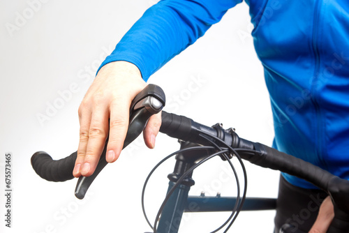 cyclist's hand on the brake lever of a bicycle steering wheel
