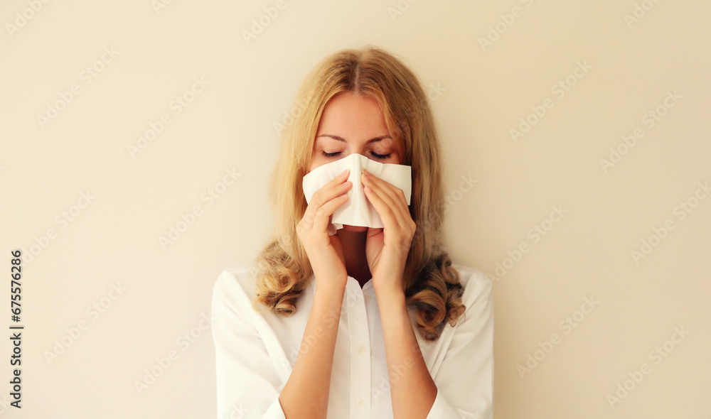 Sick exhausted caucasian young woman employee sneezing blow nose using tissue at home - obrazy, fototapety, plakaty 