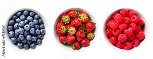 Top view of blueberries, strawberries and raspberries in bowls over isolated transparent background photo