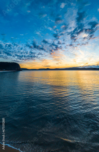 Aerial sunrise seascape with pretty cloud filled sky