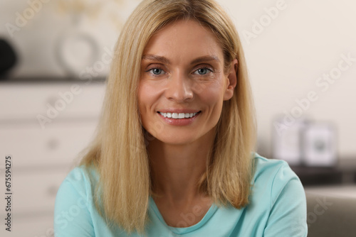 Portrait of beautiful woman with blonde hair. Attractive lady smiling and looking into camera