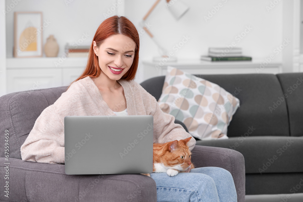 Happy woman with cat working in armchair at home Happy woman with cat working in armchair at home