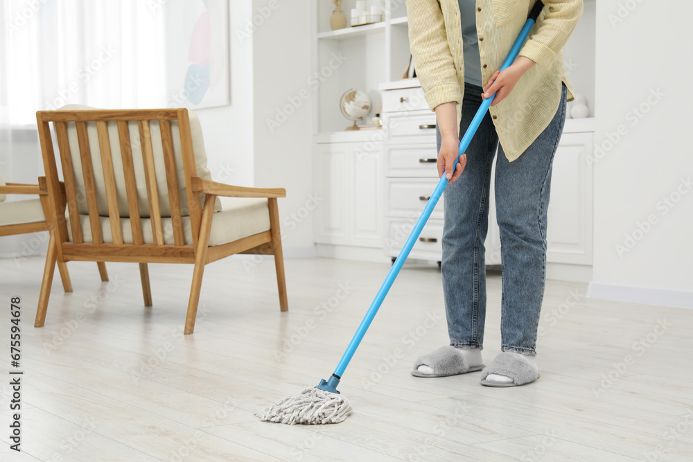 Woman cleaning dirty white parquet floor with mop at home, closeup. Space for text Woman cleaning dirty white parquet floor with mop at home, closeup. Space for text