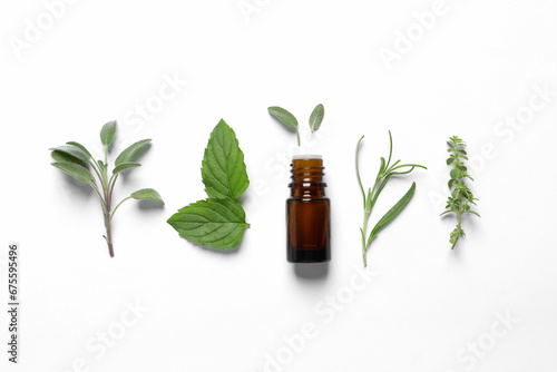Fototapeta Naklejka Na Ścianę i Meble -  Bottle of essential oil and different herbs on white background, flat lay