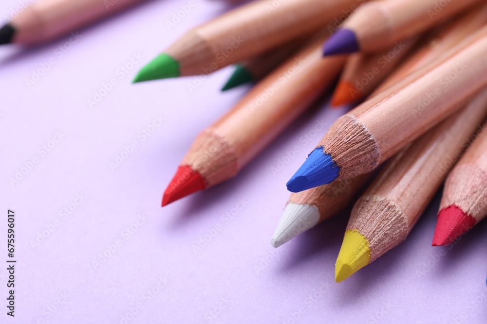 Many colorful pastel pencils on violet background, closeup. Drawing supplies Many colorful pastel pencils on violet background, closeup. Drawing supplies