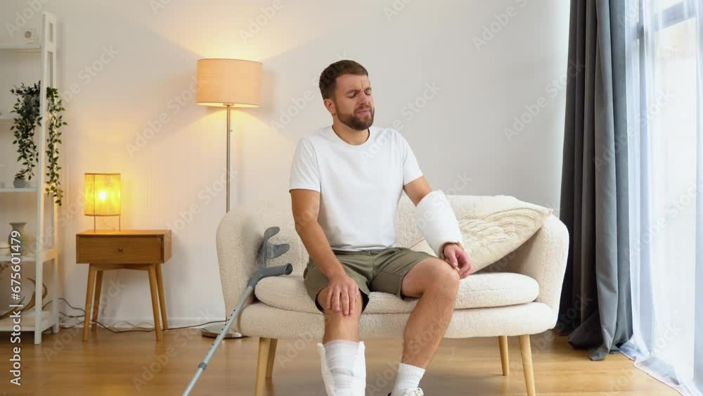 A man with crutch suffer pain from a broken leg A man with crutch suffer pain from a broken leg
