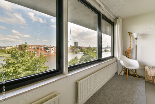 a room with a view of the water and buildings from it's window simn, taken from inside photo