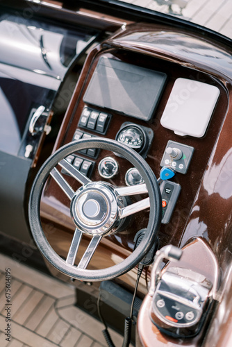Steering wheel and control panel of a modern motor yacht. Top view