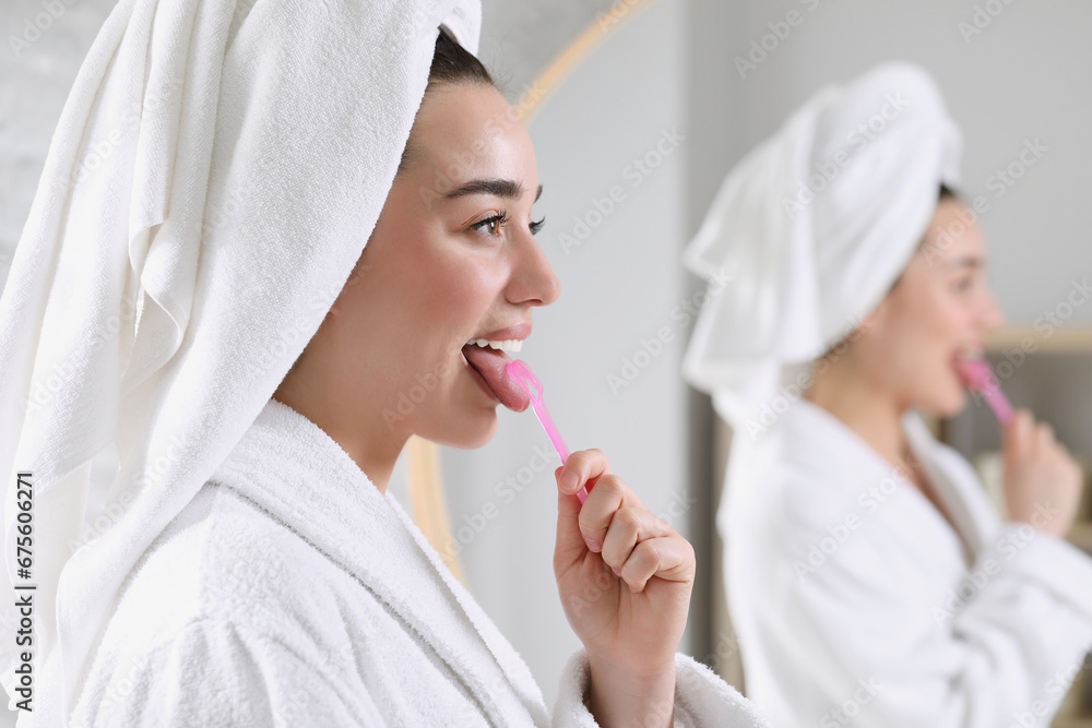 Happy woman brushing her tongue with cleaner in bathroom, space for text Happy woman brushing her tongue with cleaner in bathroom, space for text