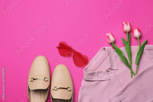 Flat lay composition with sunglasses and tulip flowers on pink background