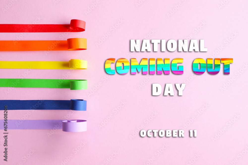 National Coming Out day, October 11. Ribbons in rainbow colors making pride flag on pink background, flat lay