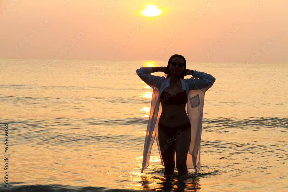 Woman pretty with bikini and silhouette on beach