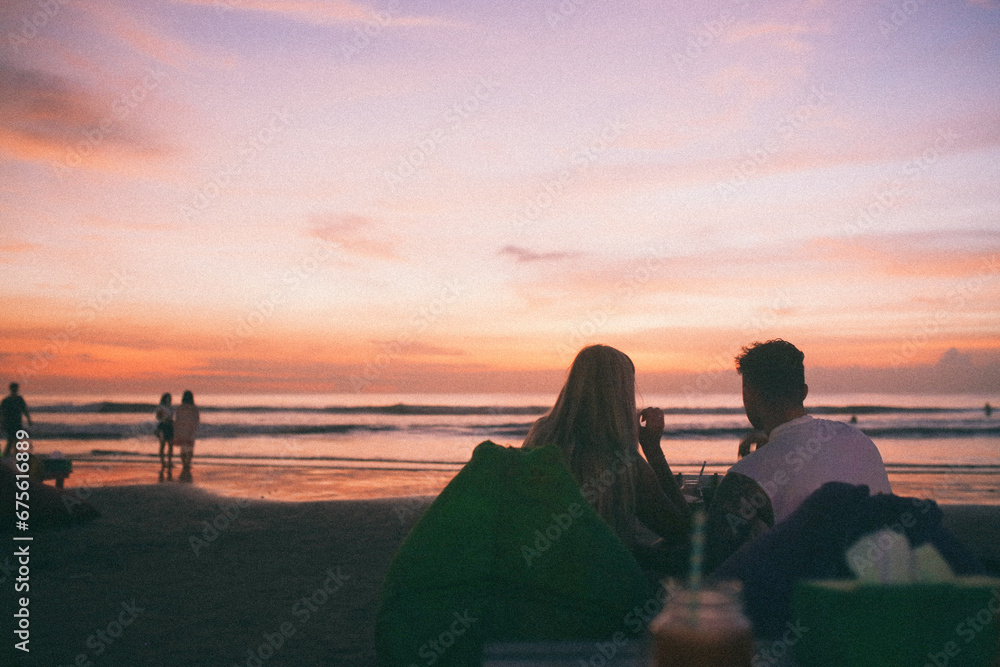 A couple enjoying their meals in the sunset of Semiyak, Bali, Indonesia