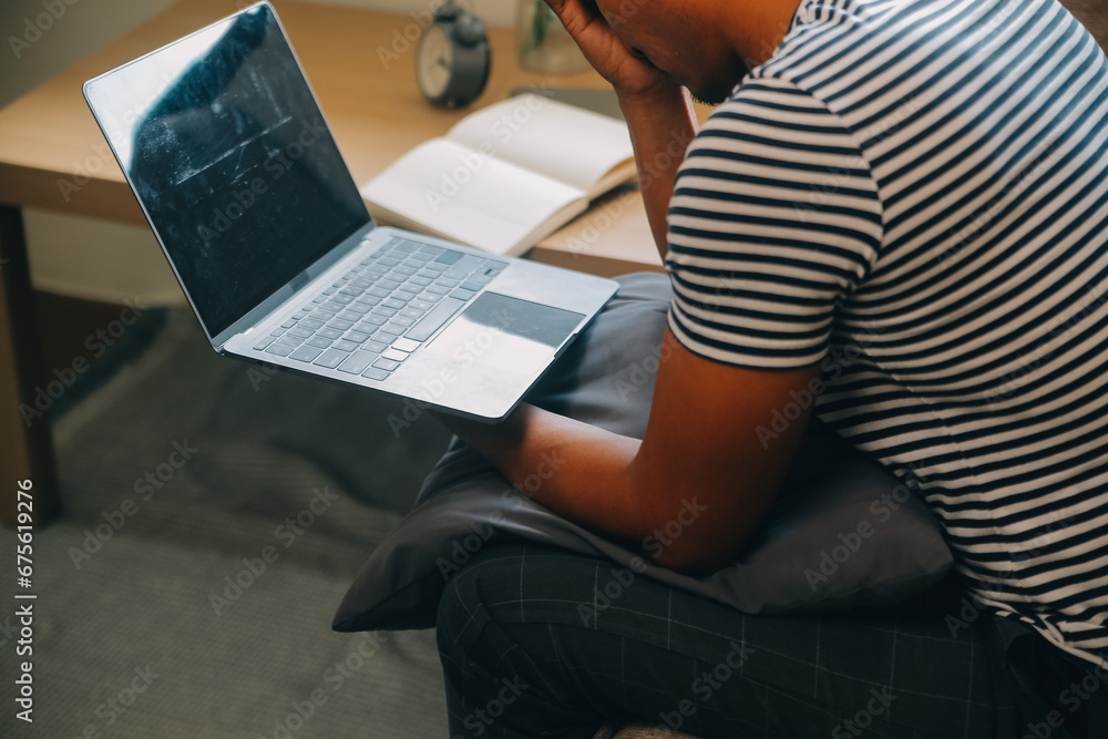 Fototapeta premium Alone man silhouette staring at the window closed with curtains in bedroom. Man stands at window alone
