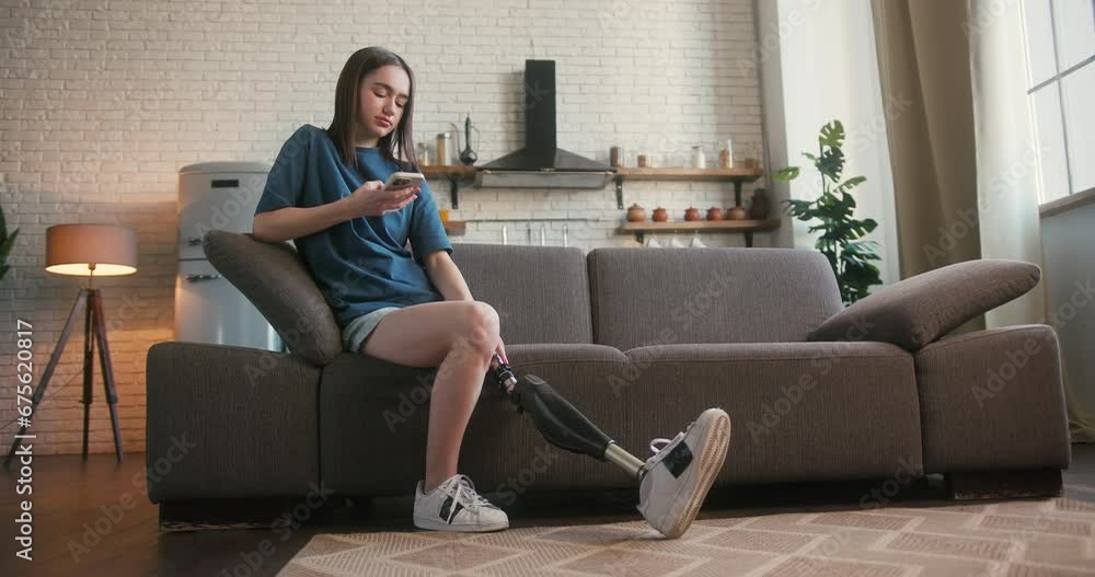 Lady with disability shares stories with friend using phone Lady with disability shares stories with friend using phone