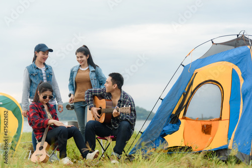 Group of Asian friends camping, relaxing by the sea, mountains Have fun drinking alcohol, partying and singing. © 2B