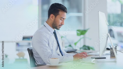 Busy male Accountant typing an email in a modern office. A financial advisor compiling a finance proposal for a successful company. A serious Auditor writing a business investment report photo