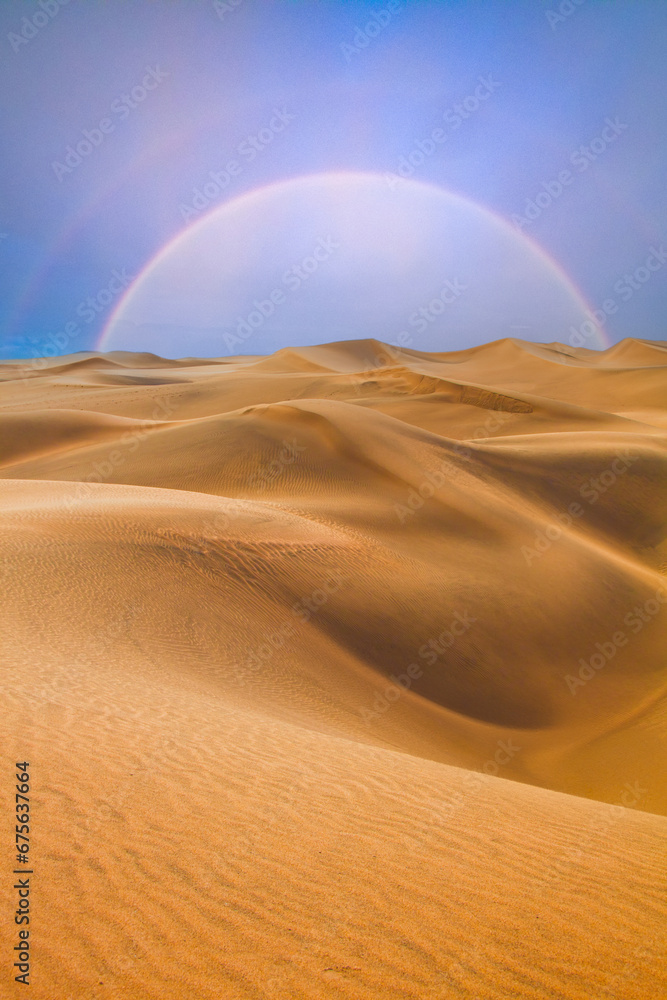 Naklejka premium desert landscape with dunes and a rainbow on the horizon