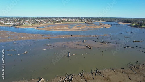 Over the dead tress lying in the mud of Lake Mulwala with the bridge and town of Yarrawonga in the background photo