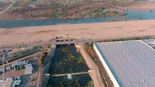 Santa Fe Dam filled to the rim after historically high rainfall in 2023 - tilt down aerial reveal photo