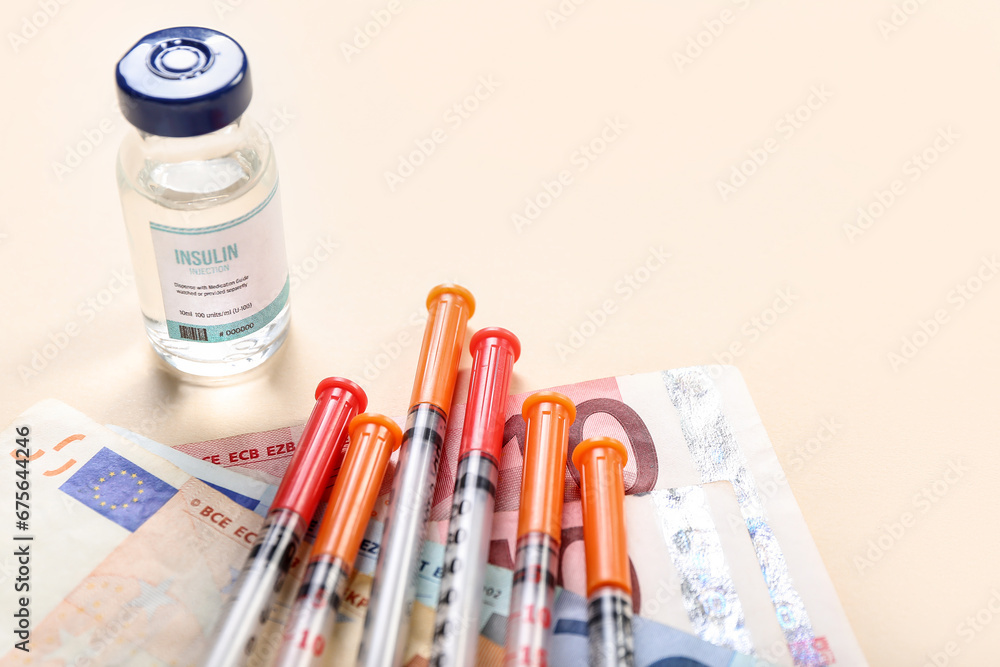 Insulin with syringes and money on beige background, closeup. Expensive medicine concept Insulin with syringes and money on beige background, closeup. Expensive medicine concept