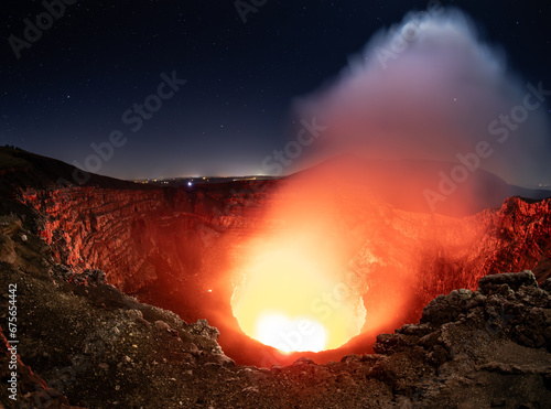 A view into the crater with bubbling lava, molten magma,  and gases of the majestic and still active Masaya volcano in Nicaragua, Central America photo
